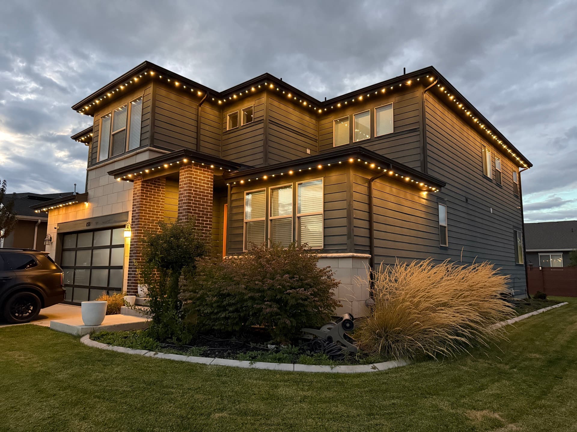 Elegant home with permanent LED lights creating ambiance at dusk