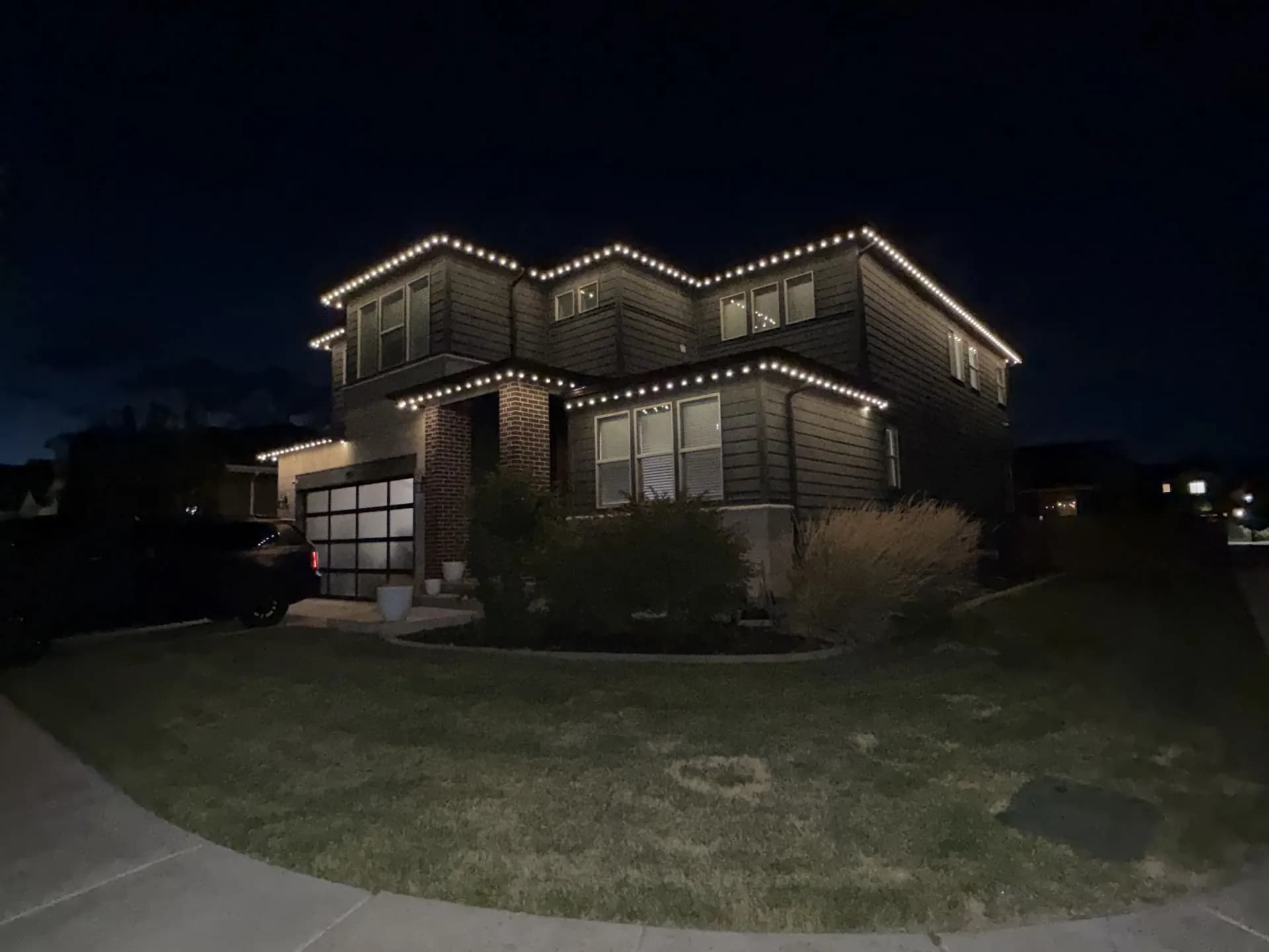 Home exterior with permanent LED lights showcasing evening curb appeal